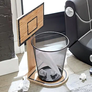 A cylindrical mesh trash bin with a wooden basketball hoop and backboard mounted on top, featuring a natural wood frame and black metal rim for a playful waste disposal solution.